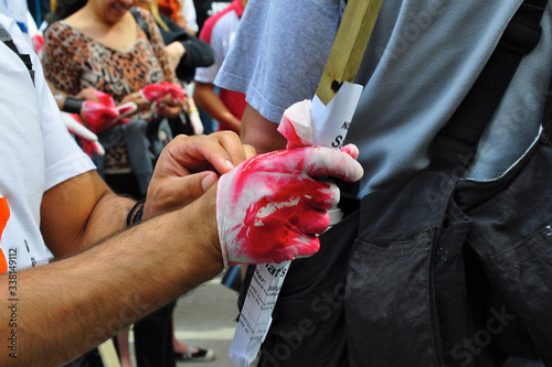 Photography View of the bloody rubber glove to symbolize the war crime on the peace demonstr
