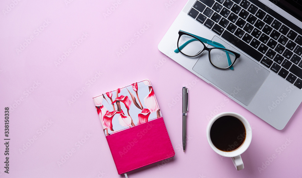 Home work. Business flat lay with cup of coffee, notebook, eye glasses, pencil  on pink background