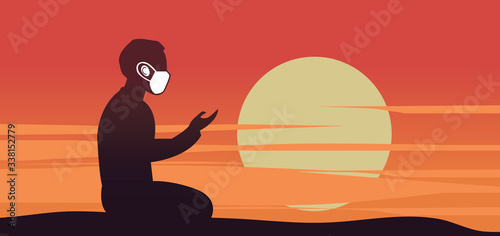 The fasting man in a protective surgical mask prays for Ramadan eid mubarak  coronavirus....