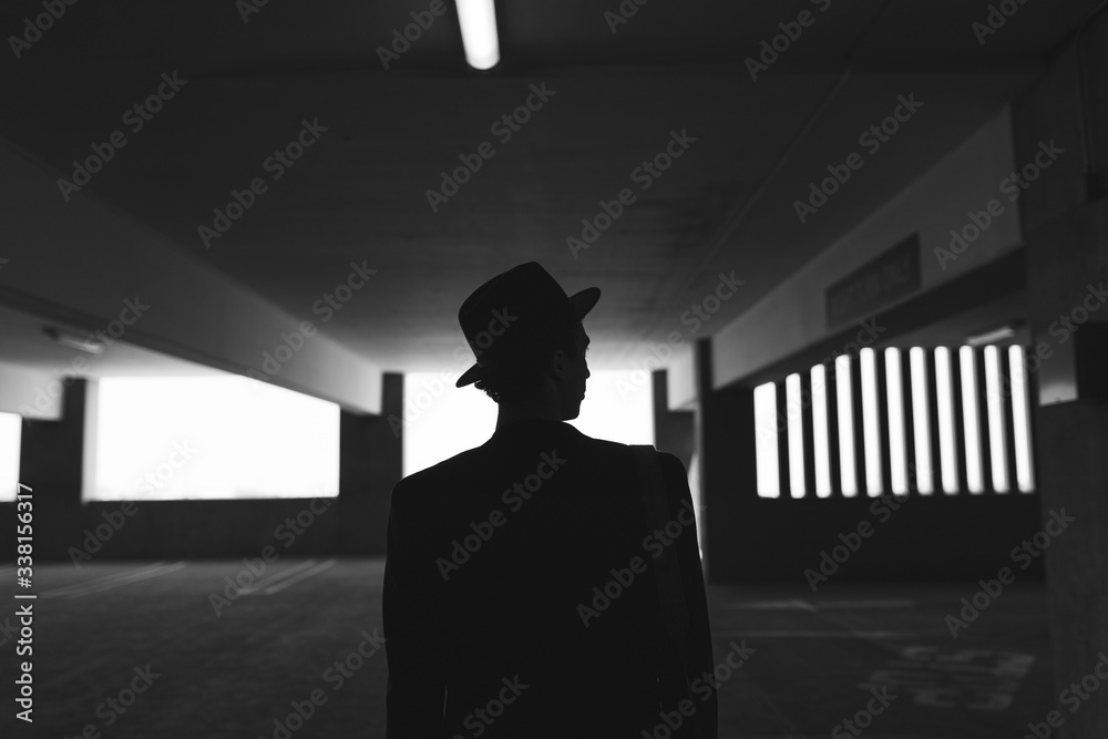 Obraz premium Rear view of man standing in parking lot