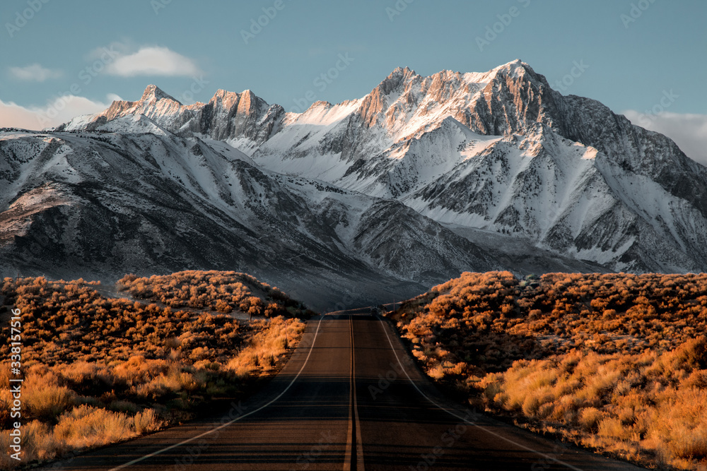 View of road leading towards snowy mountains - obrazy, fototapety, plakaty 