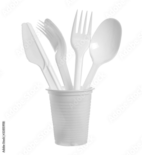 Plastic cutlery, knives, spoons and forks inside cup isolated on white background with clipping path