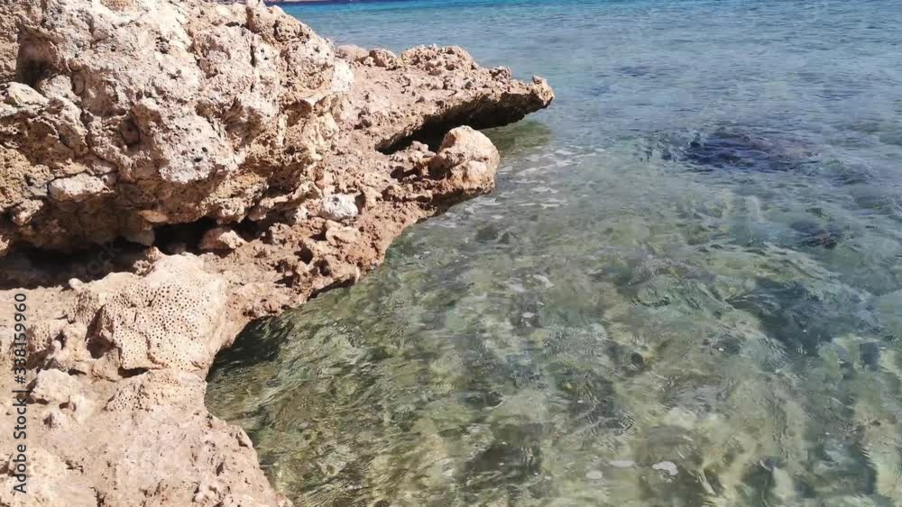 Waves of the Red Sea crash against a stone rock in Sharm El Sheikh (Egypt) (20). Beautiful seascape on a sunny summer day Waves of the Red Sea crash against a stone rock in Sharm El Sheikh (Egypt) (20). Beautiful seascape on a sunny summer day