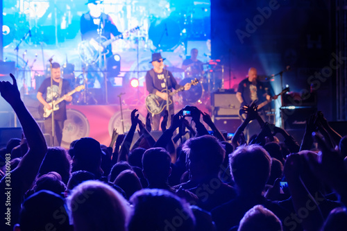 Fototapeta Naklejka Na Ścianę i Meble -  Fans at live rock music concert cheering