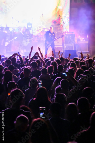 Fans at live rock music concert cheering