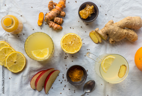 Various immune boosting citrus drinks with ginger and turmeric photo