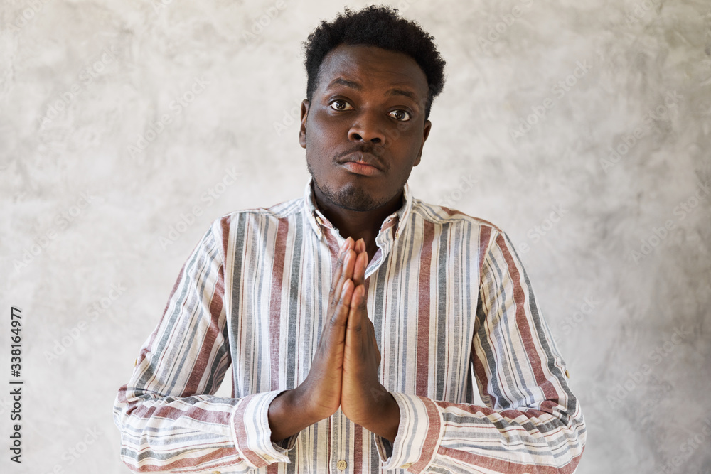 Please forgive me. Isolated shot of handsome young African guy in ...