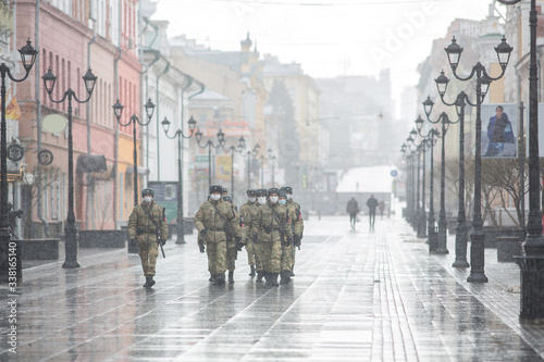 Bolshaya Pokrovskaya street in Nizhny Novgorod without people during a snowfall masks a military patrol restricting the movement of people during quarantine on coronavirus (chovid-19)