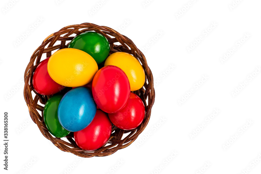 Colorful easter eggs in nest basket isolated on white background. Top view. Colorful easter eggs in nest basket isolated on white background. Top view.