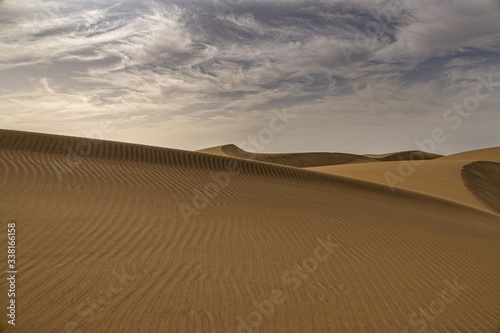 summer desert landscape on a warm sunny day from Maspalomas dunes on the Spanish island of Gran Canaria