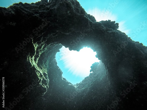 Low angle view of heart shape rock formation in sea © Jeremy Bishop