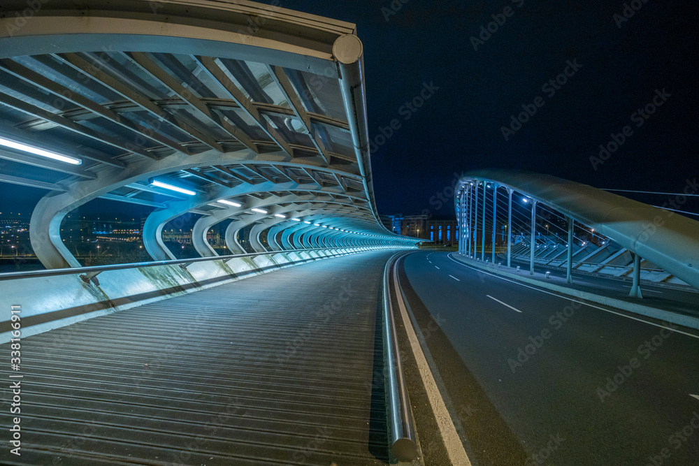 Fototapeta premium bridge with tubular structure, illuminated without people