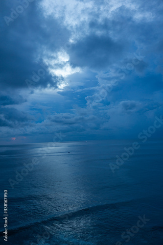 Wallpaper Mural Beautiful blue sunset on the ocean with big waves and cliffs and cliffs. Bali island with its tropical and exotic nature. Sunrise over the sea and ocean. Phantom blue in sunset Torontodigital.ca