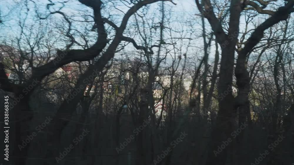 Views of Budapest from window of moving gear train through bare winter trees Views of Budapest from window of moving gear train through bare winter trees
