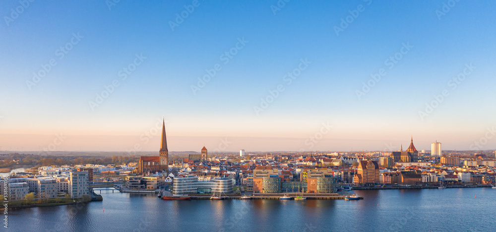 port of rostock at sunrise - view over the river warnow, skyline of rostock