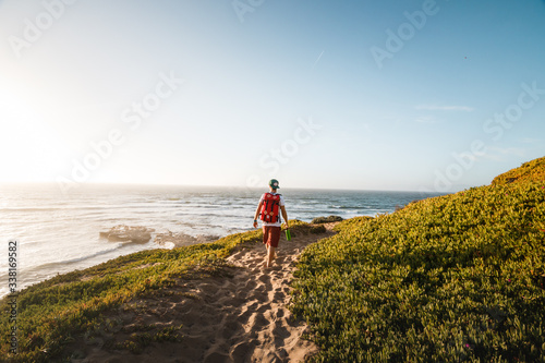Rear view of hiker walking on coastal path © Jeremy Bishop