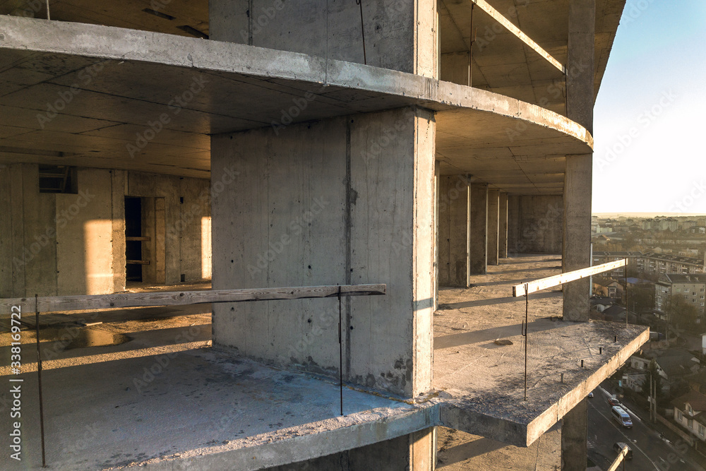 Aerial view of concrete frame of tall apartment building under construction in a city. Aerial view of concrete frame of tall apartment building under construction in a city.