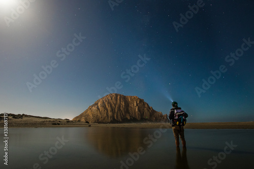 Rear view of man stargazing at Morro Rock Beach