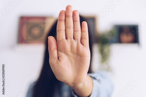 Coronavirus concept. Girl says stop with her hands to coronavirus. Global call to stay home.