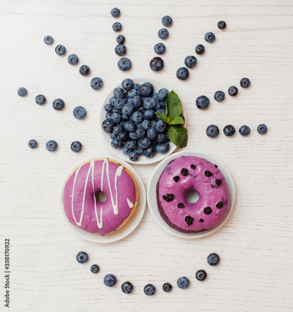 muzzle of berries and donuts, Indian. Sweet tasty donuts and berries on a colored background muzzle of berries and donuts, Indian. Sweet tasty donuts and berries on a colored background