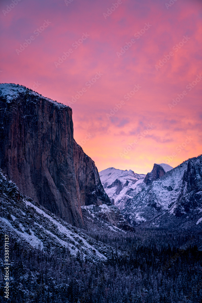 Fototapeta premium Dramatic sunset over snowy mountains in winter