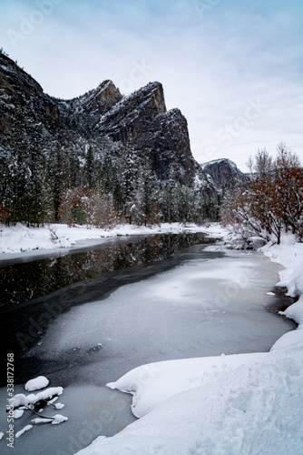 View of frozen river and mountains in winter