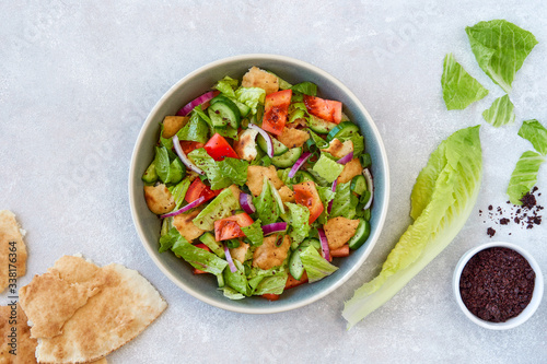 Traditional lebanese bread salad fattoush with ingredients . Top view with copy space                       