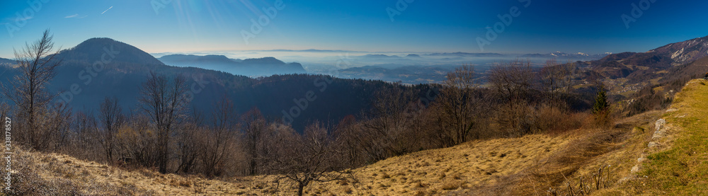 Panorama of a view from church on Sveti Primoz, a well known hiking spot in Karavanke alps, just above Kamnik, Slovenia. Visible Ljubljana and Kamnik basin in the clouds.