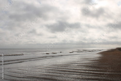 Fototapeta Naklejka Na Ścianę i Meble -  beach and sea along the coast of East England on a cloudy evening.