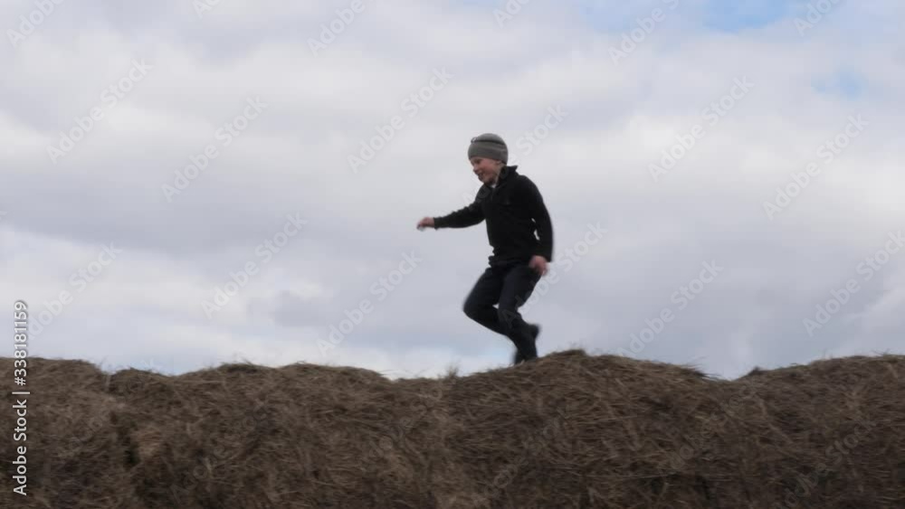 child play with a stack of straw against the sky child play with a stack of straw against the sky