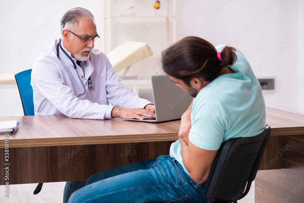 Injured young man visiting old doctor Injured young man visiting old doctor
