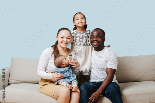Cheerful happy family posing for a family photo in a studio
