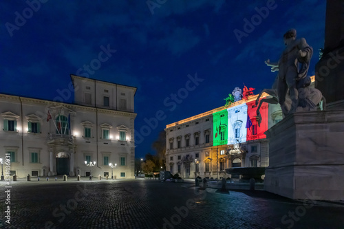 Palazzo della Consulta, illuminated with the colors of the Italian flag, in the evening in the blue hour.