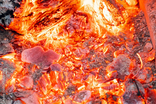 Smoldering charcoal in a bonfire, background texture