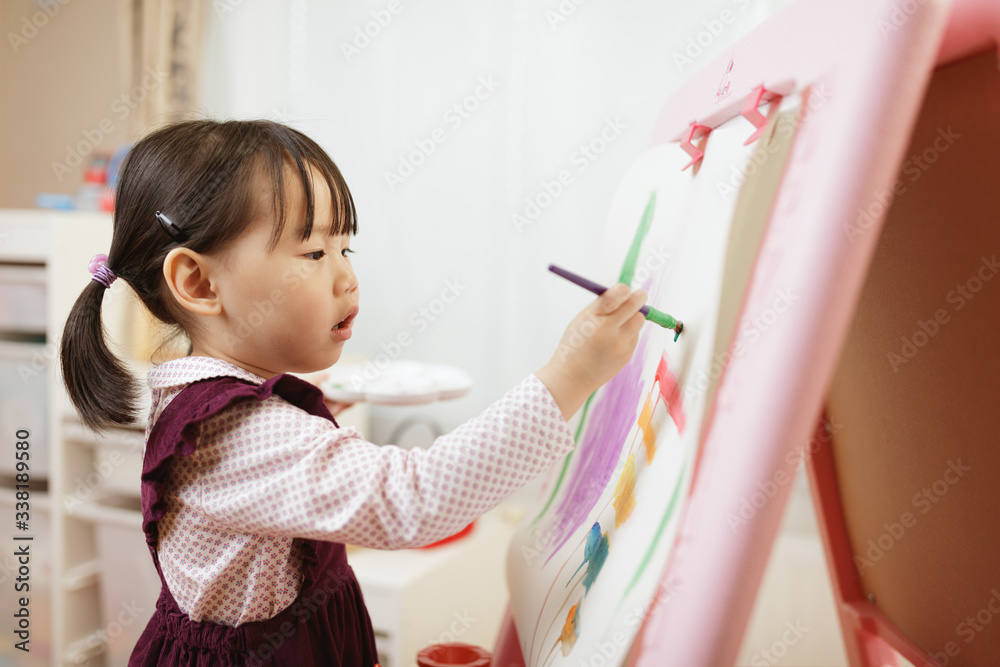 toddler girl practice watercolor paiting at home agianst white background toddler girl practice watercolor paiting at home agianst white background