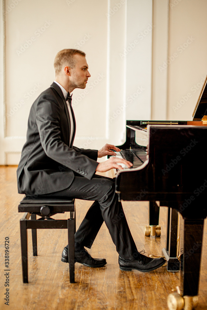 young caucasian male pianist perform classical music, man practice playing  piano before his first concert or performance on a stage Stock Photo |  Adobe Stock