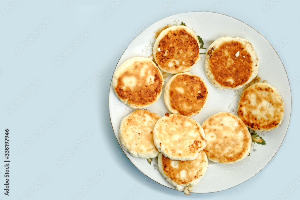curd pancake on a white plate. blue table background. curd pancake on a white plate. blue table background.