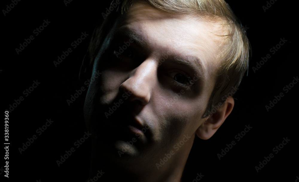 Fototapeta premium portrait of a guy in dramatic lighting