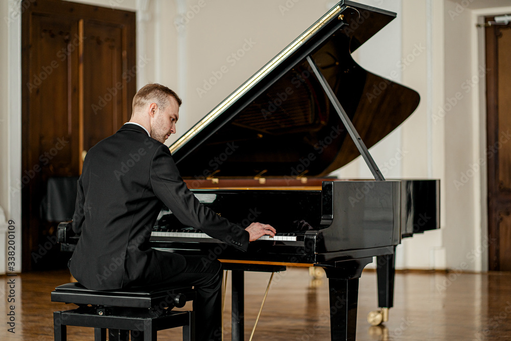 young handsome caucasian man in formal elegant suit gracefully play