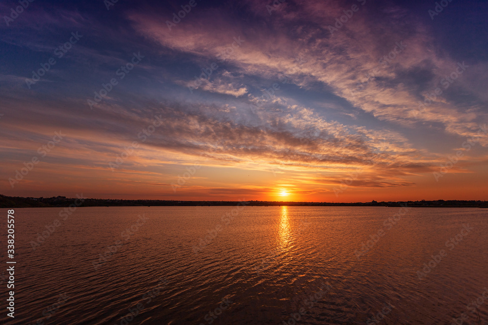 Beautiful sunset on the lake with clouds and reflections on the water Beautiful sunset on the lake with clouds and reflections on the water