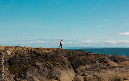 Man on rocks on Scottish coast