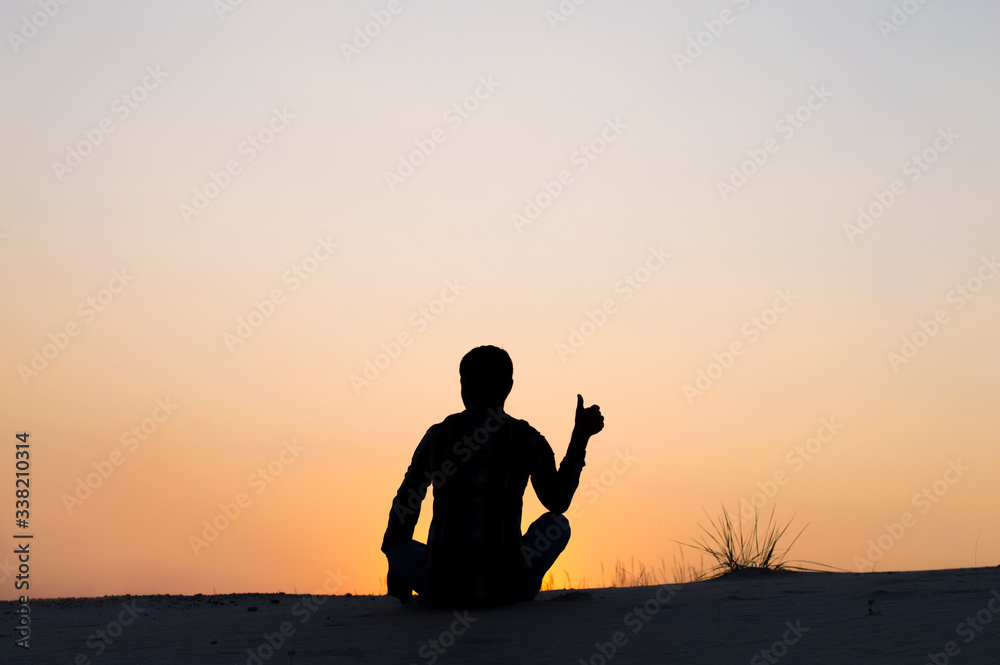 silhouette photo man sitting on sky background