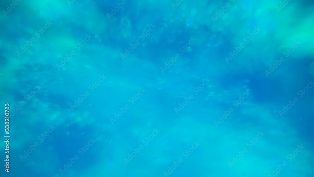 CU, macro view: beautiful sky blue water streams with bubbles and sparkles run past camera at bright light closeup CU, macro view: beautiful sky blue water streams with bubbles and sparkles run past camera at bright light closeup