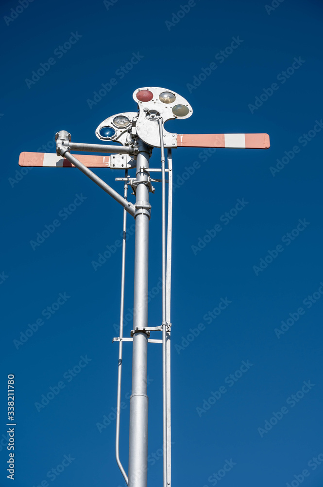 The arms of the old train signal are pointed out on the signal post. The arms of the old train signal are pointed out on the signal post.