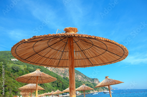 Fototapeta Naklejka Na Ścianę i Meble -  reed beach umbrellas at exotic tropical beach