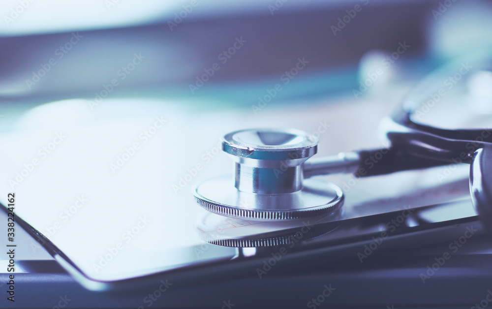 Medical equipment: blue stethoscope and tablet on white background. Medical equipment Medical equipment: blue stethoscope and tablet on white background. Medical equipment