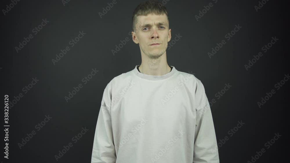 thin blue eyed guy in grey pullover poses for photo shoot thin blue eyed guy in grey pullover poses for photo shoot