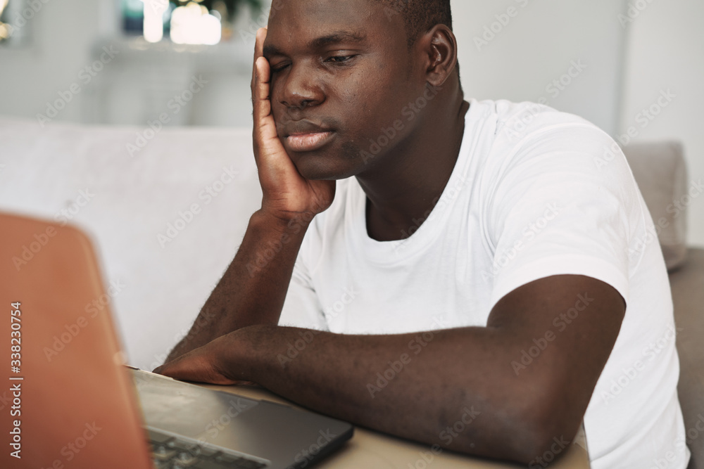 man sitting on sofa with laptop