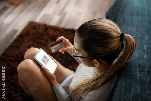Young White Woman Using Smartphone Shopping Online With Credit Card
