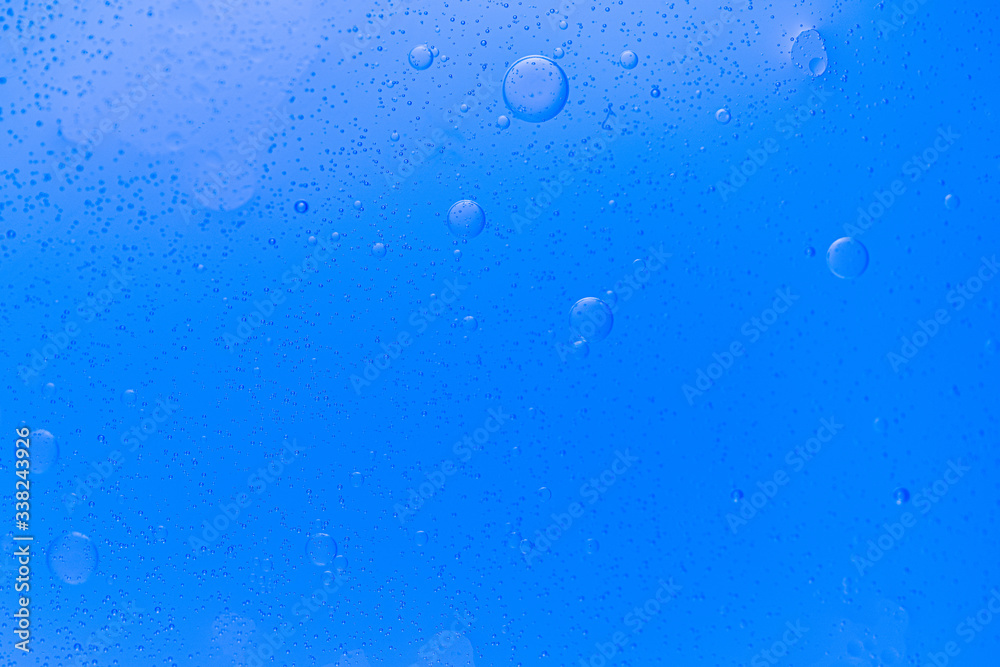 Abstract  Underwater air bubbles, round shape, water frozen in time, blue background, clean backdrop texture